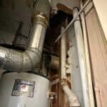 Vanguard water heater with its metal flue pipe extending upwards